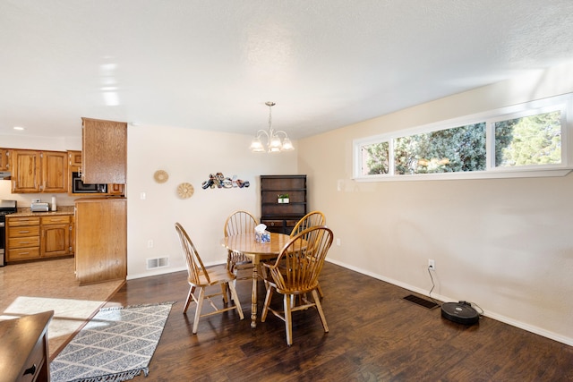 dining area with a chandelier and hardwood / wood-style flooring