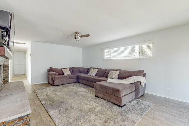 living room featuring ceiling fan and light wood-type flooring