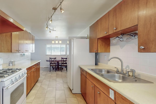 kitchen with sink, ventilation hood, white appliances, decorative backsplash, and light tile patterned floors