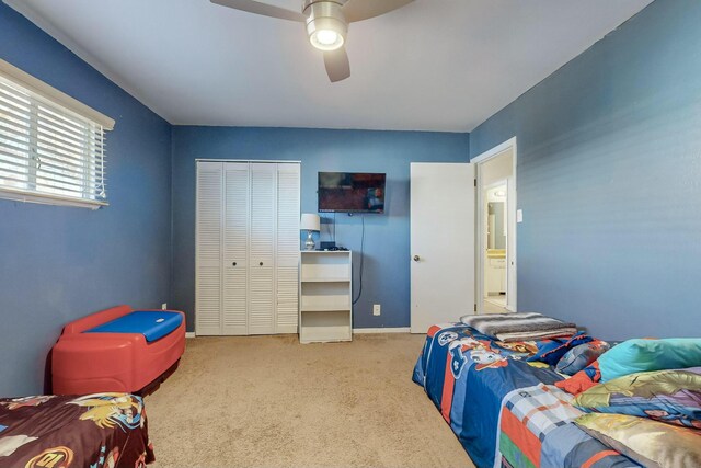 bedroom featuring ceiling fan, a closet, and carpet floors