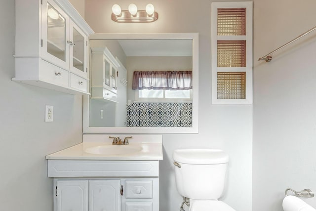 bathroom with vanity and toilet