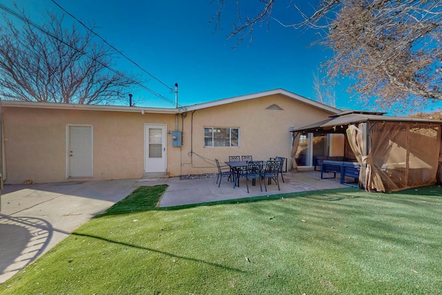 back of property featuring a gazebo, a patio area, and a yard