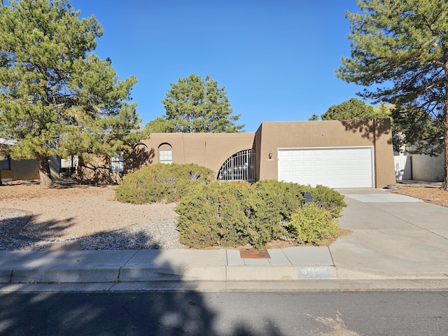 pueblo-style house with a garage