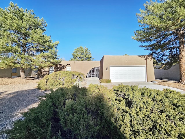 pueblo-style home featuring a garage