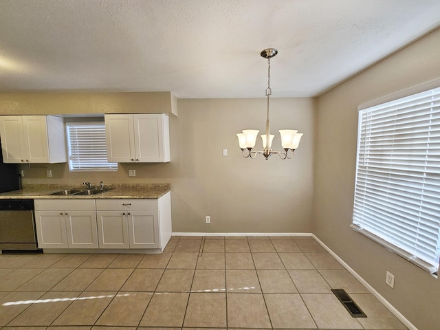 kitchen featuring white cabinetry, dishwasher, sink, pendant lighting, and light tile patterned floors