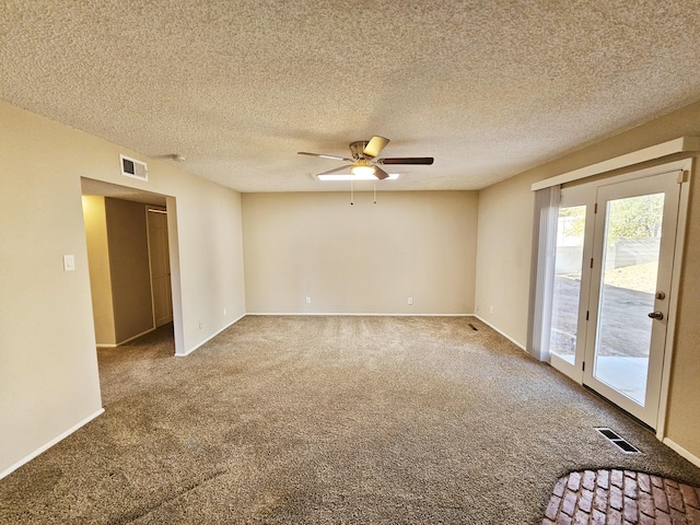 carpeted empty room featuring a textured ceiling and ceiling fan