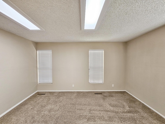 carpeted spare room featuring a textured ceiling