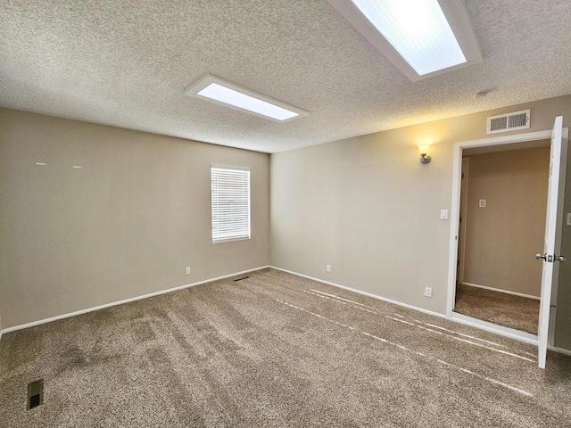 carpeted spare room with a textured ceiling