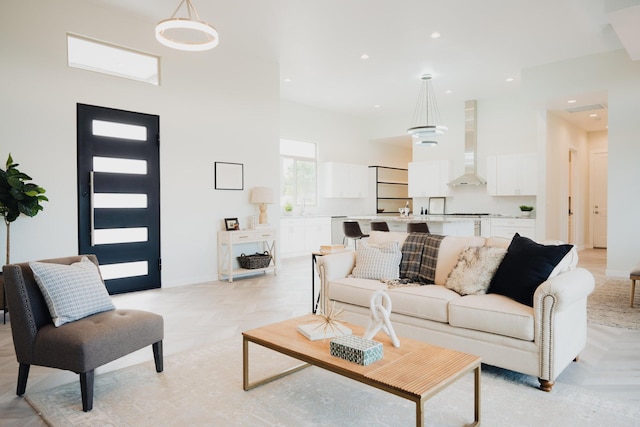 living room with light parquet flooring and a high ceiling