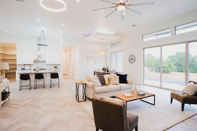 living room with ceiling fan and light parquet flooring