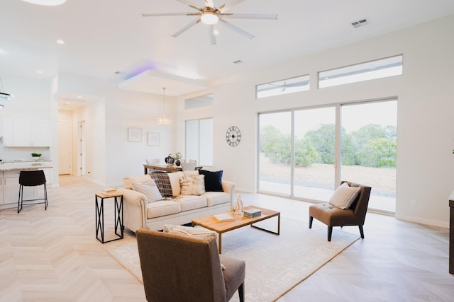 living room featuring ceiling fan and light parquet flooring