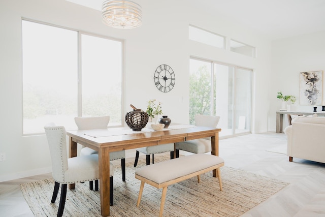 dining room with light parquet floors and plenty of natural light