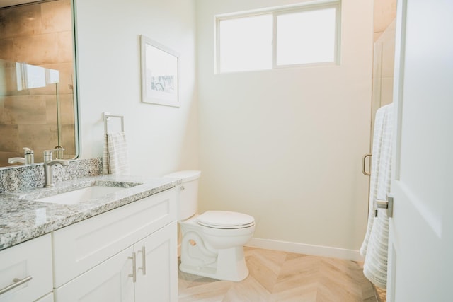 bathroom featuring vanity, toilet, and a shower with shower door