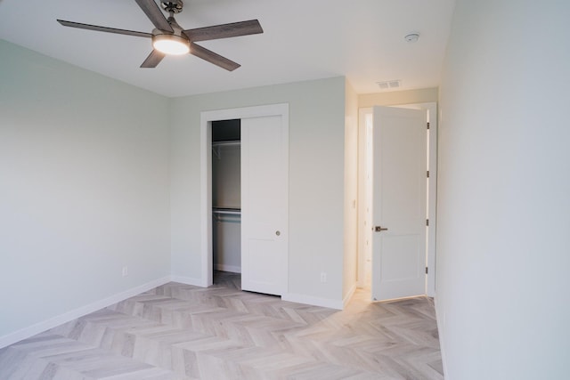 unfurnished bedroom with ceiling fan, a closet, and light parquet floors