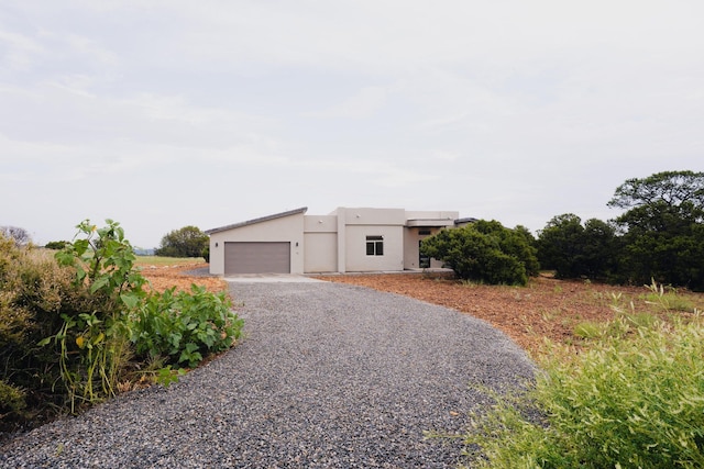 pueblo-style home featuring a garage