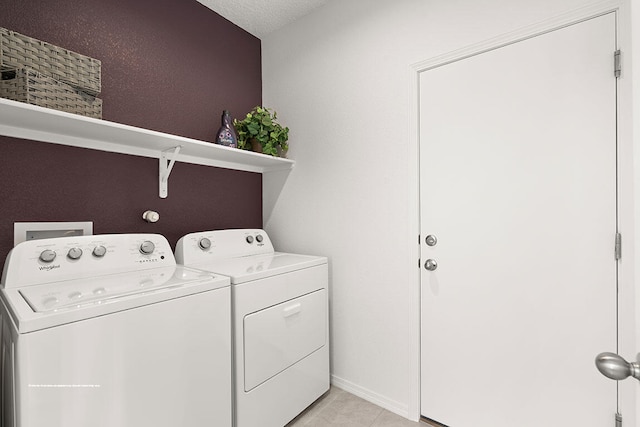 clothes washing area featuring a textured ceiling and washing machine and clothes dryer