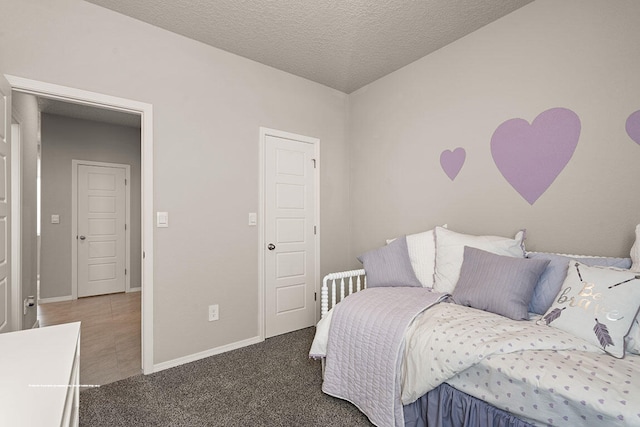 carpeted bedroom featuring a textured ceiling