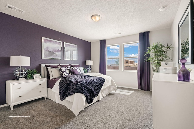 carpeted bedroom with a textured ceiling