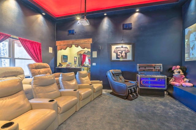 home theater with carpet and a high ceiling