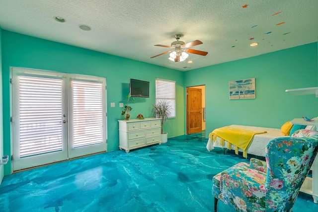 carpeted bedroom featuring ceiling fan and a textured ceiling