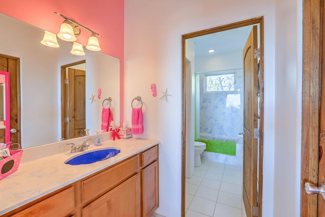 bathroom with toilet, tile patterned floors, and vanity