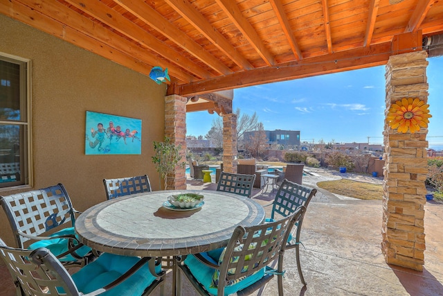 view of patio with a view of city and outdoor dining area