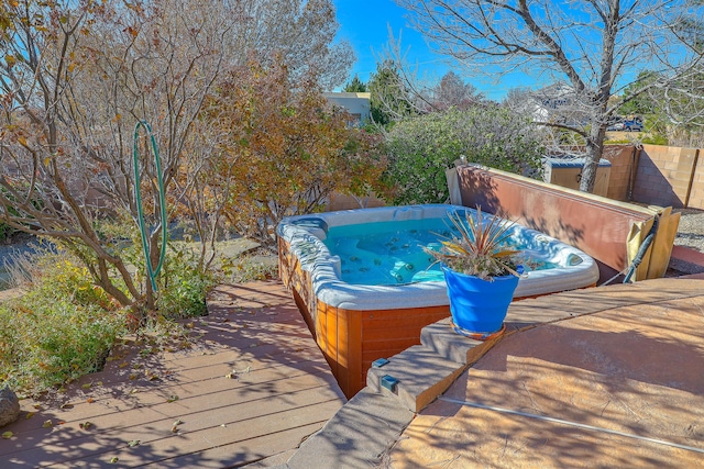 wooden terrace with a covered hot tub