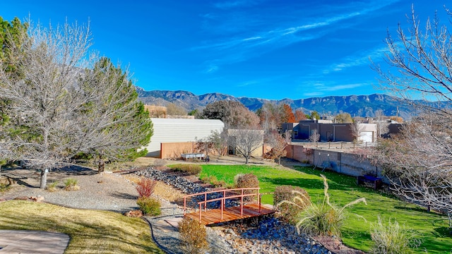 view of yard with fence and a mountain view