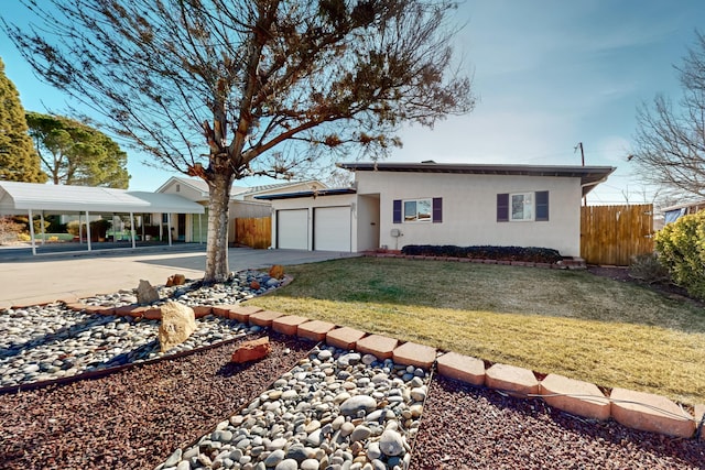 ranch-style house featuring a front lawn, a garage, and a carport