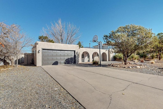 pueblo revival-style home with a garage