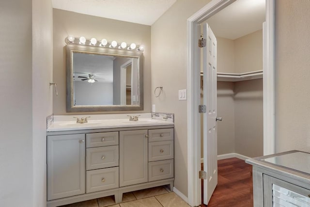 bathroom featuring ceiling fan, vanity, and wood-type flooring