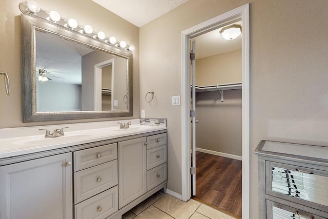 bathroom featuring hardwood / wood-style floors, vanity, a textured ceiling, and ceiling fan