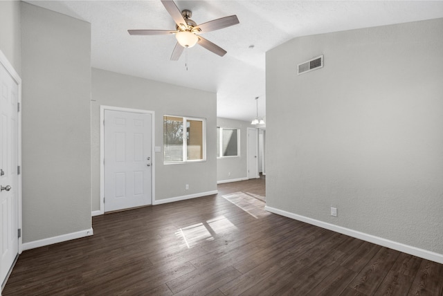 unfurnished living room with ceiling fan with notable chandelier, dark hardwood / wood-style flooring, and lofted ceiling