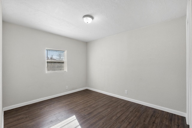 spare room with dark hardwood / wood-style floors