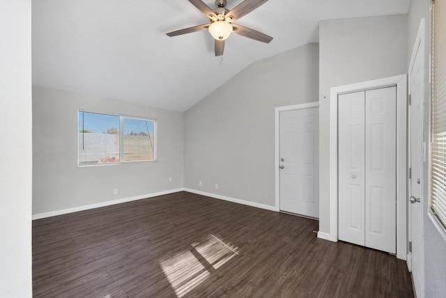 unfurnished bedroom with dark hardwood / wood-style flooring, vaulted ceiling, and ceiling fan