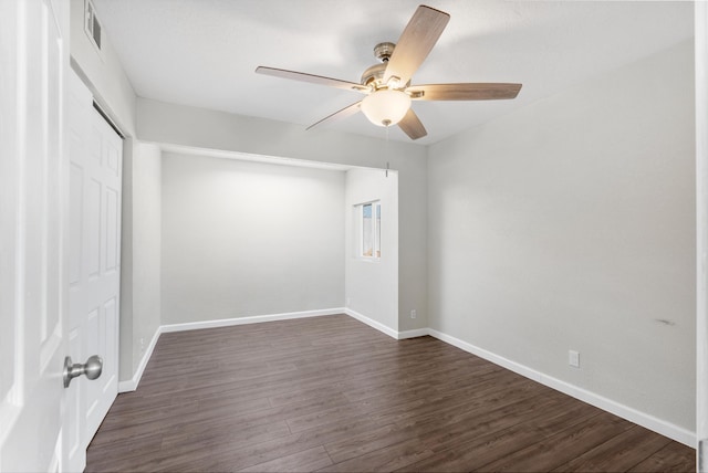 unfurnished room with ceiling fan and dark wood-type flooring