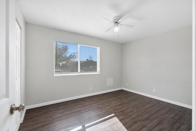 unfurnished room featuring dark hardwood / wood-style floors, ceiling fan, and a textured ceiling