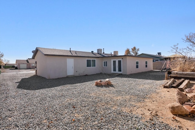 back of house with french doors and central AC unit