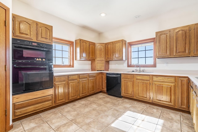 kitchen featuring a wealth of natural light, sink, light tile patterned flooring, and black appliances