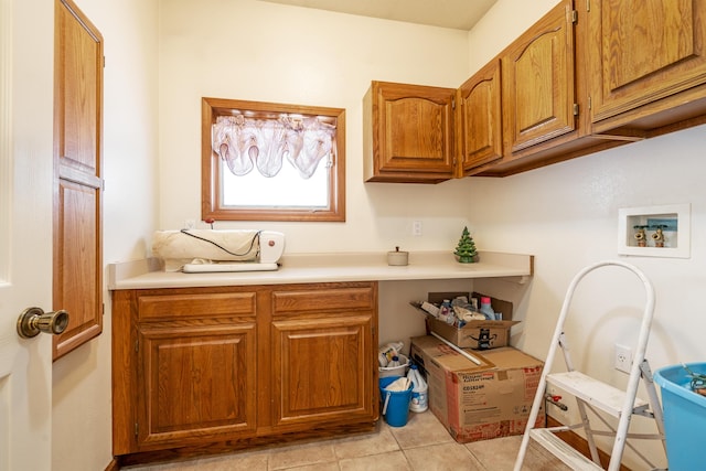 laundry room with cabinets, hookup for a washing machine, and light tile patterned flooring