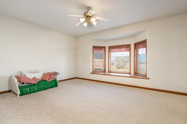 interior space with carpet and ceiling fan