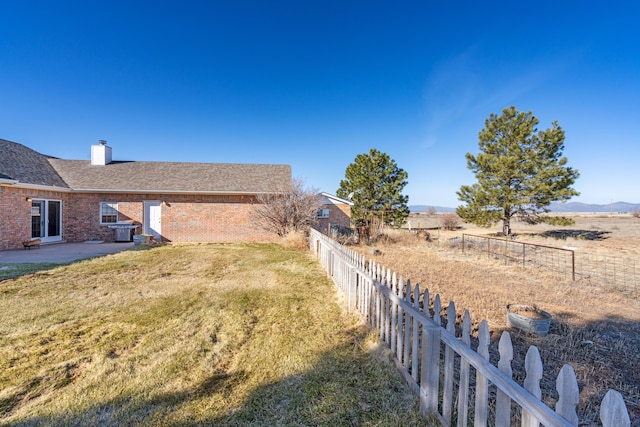 view of yard with a patio area, a mountain view, a rural view, and central AC