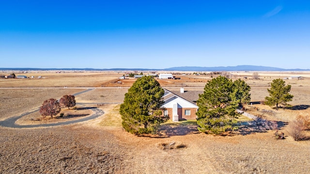 birds eye view of property featuring a mountain view and a rural view