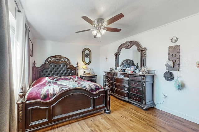 bedroom featuring hardwood / wood-style flooring and ceiling fan