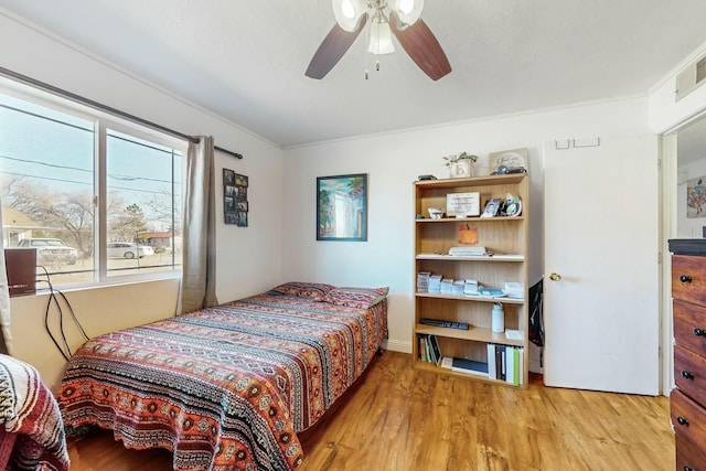 bedroom with light hardwood / wood-style floors and ceiling fan