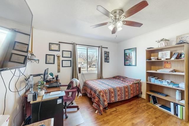 bedroom featuring ceiling fan and hardwood / wood-style flooring