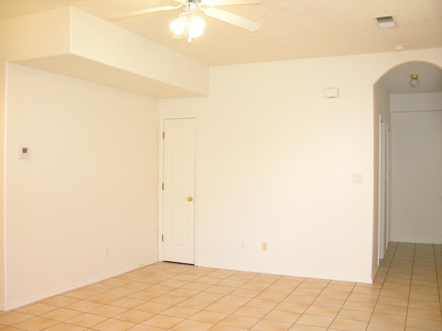 empty room featuring light tile patterned floors and ceiling fan