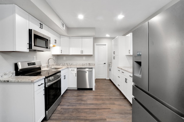 kitchen featuring sink, white cabinets, dark wood-type flooring, and appliances with stainless steel finishes