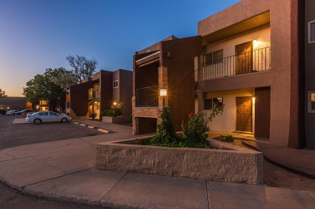 view of outdoor building at dusk