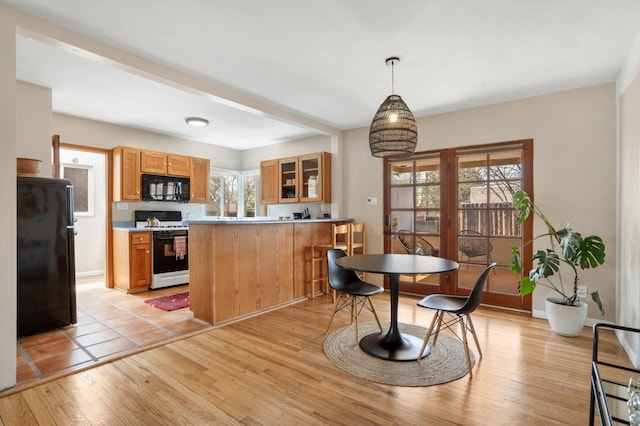 dining area featuring baseboards and light wood-style floors